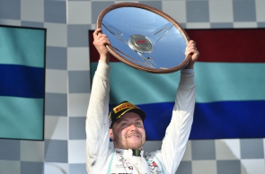 Mercedes' Finnish driver Valtteri Bottas celebrates on the podium after winning the Formula One Australian Grand Prix in Melbourne on March 17, 2019. (Photo by PETER PARKS / AFP) / -- IMAGE RESTRICTED TO EDITORIAL USE - STRICTLY NO COMMERCIAL USE --