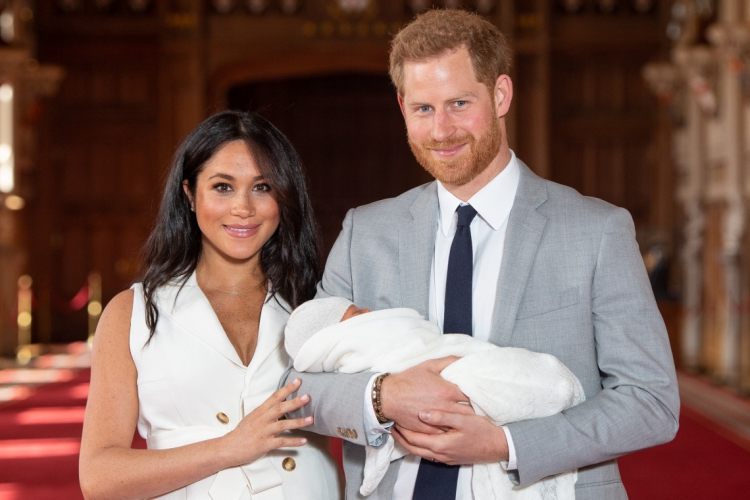 Britain's Prince Harry, Duke of Sussex (R), and his wife Meghan, Duchess of Sussex, pose for a photo with their newborn baby son, Archie Harrison Mountbatten-Windsor, in St George's Hall at Windsor Castle in Windsor, west of London on May 8, 2019. (Photo by Dominic Lipinski / POOL / AFP)