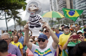 People demonstrate to show their support to the federal government and against the release of former Brazilian president Luiz Inacio Lula da Silva from prison, at Sao Conrado beach in Rio de Janeiro, Brazil, on November 9, 2019. - Brazil's leftist icon Luiz Inacio Lula da Silva walked free from jail Friday after a year and a half behind bars for corruption following a court ruling that could release thousands of convicts. (Photo by Mauro PIMENTEL / AFP)