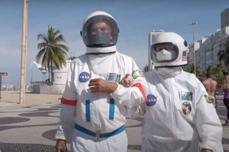 Brazilian accountant Tercio Galdino, 66, puts a helmet on as he prepares to go to Copacabana beach in protective suit, in Rio de Janeiro, Brazil on July 12, 2020.