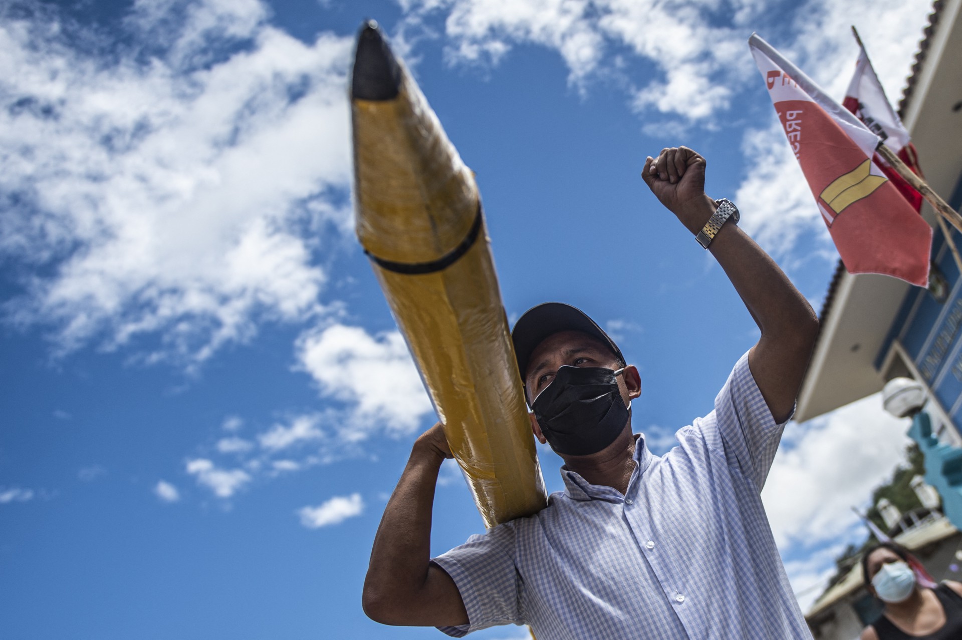 ￼ MILITANTE do candidato do partido Peru Libre, Pedro Castillo, segura um lápis gigante, símbolo da campanha (Foto: ERNESTO BENAVIDES / AFP)