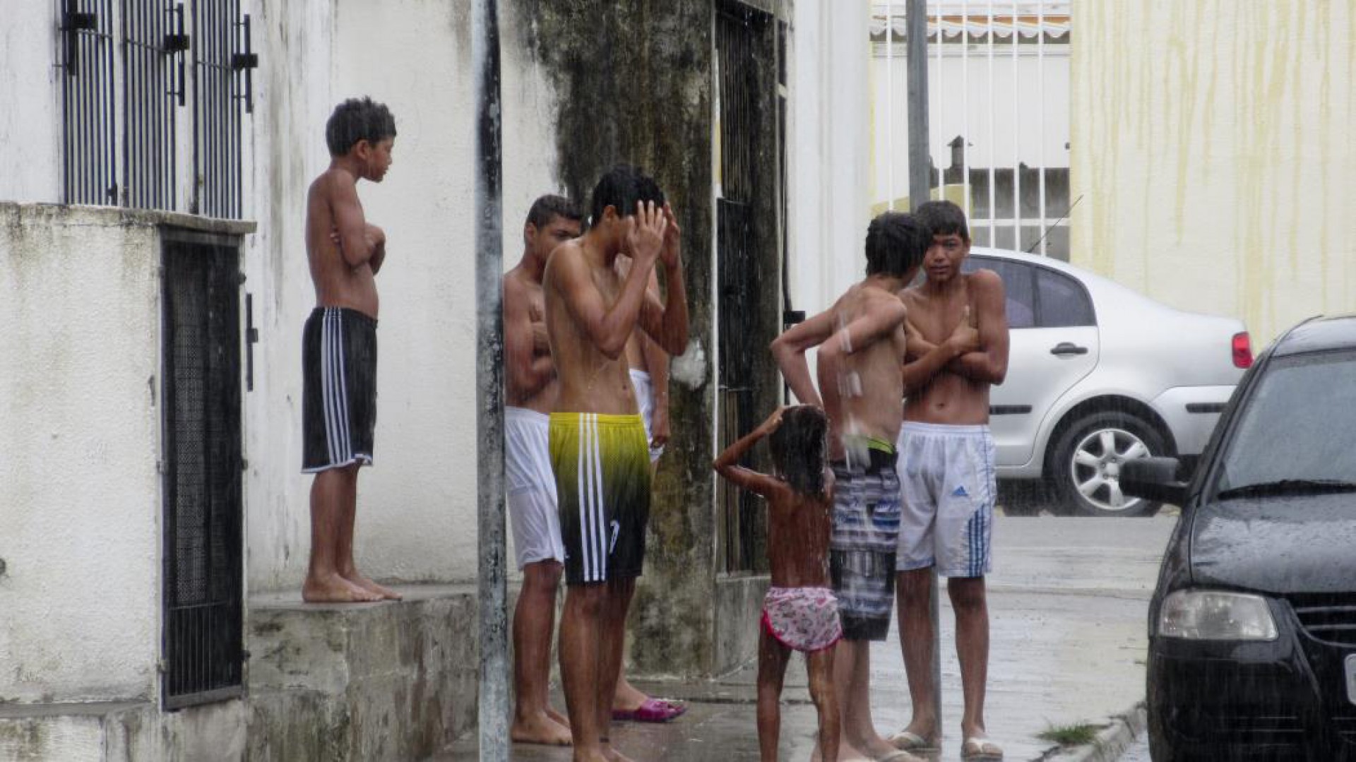Crianças tomam banho de chuva em rua do bairro José Bonifácio. O banho de bica faz parte da cultura cearense (Foto: Fco Fontenele)