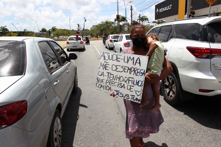 Rosimeire Silva, 32 com seu filho pedindo no sinal da avenida Aguanambi(Foto: FABIO LIMA)