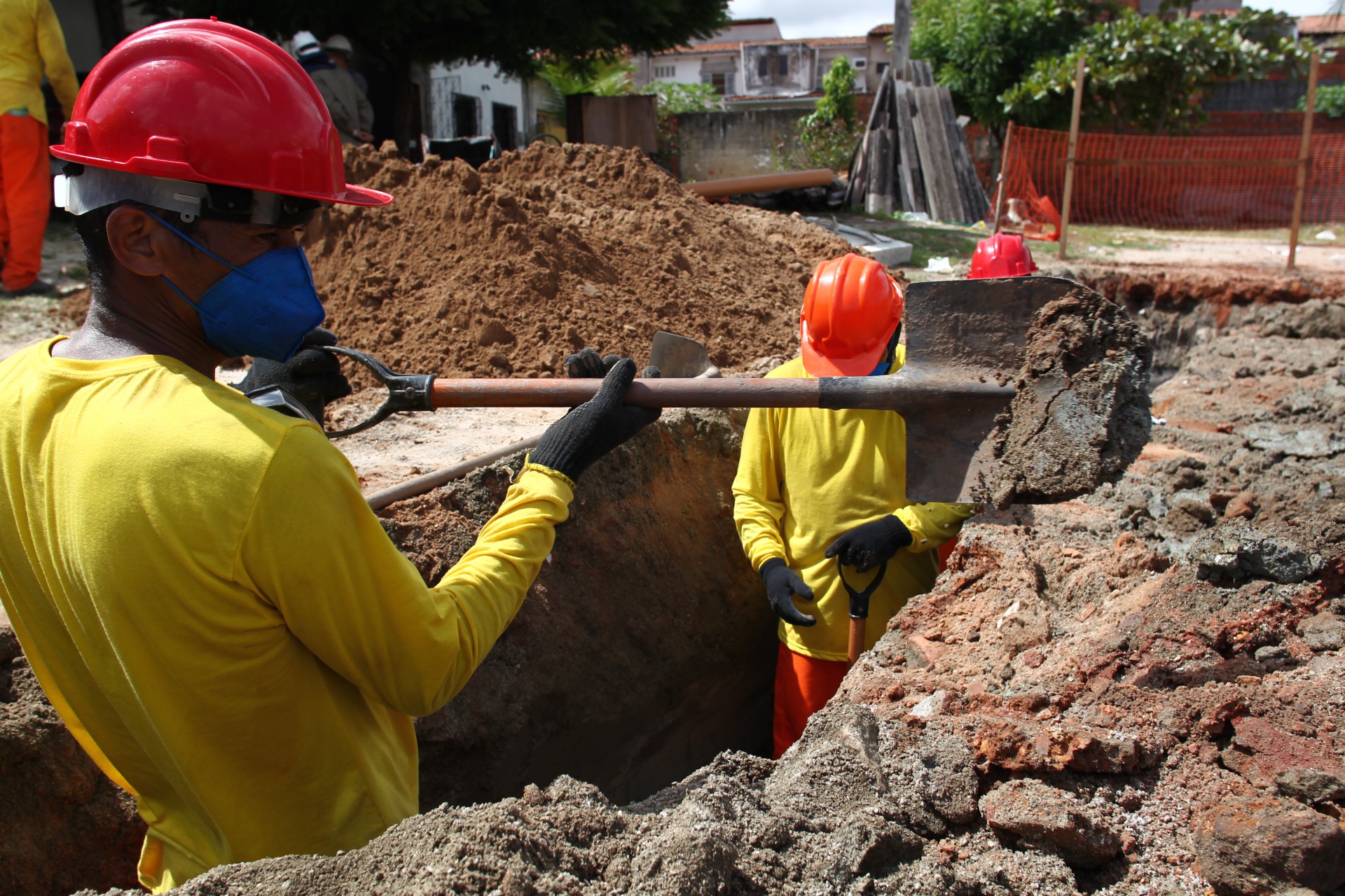 Homens trabalham na ampliação do sistema de esgotamento sanitário no bairro Cajazeiras (Foto: FABIO LIMA)