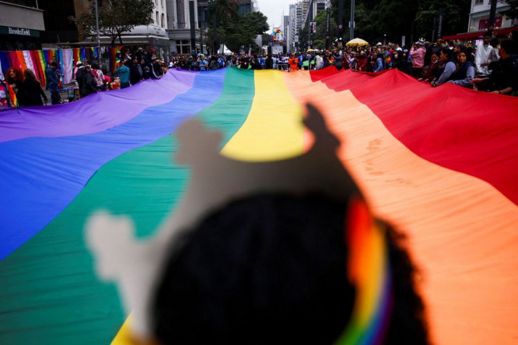 People carry a large rainbow flag as they march through Paulista Avenue to celebrate LGBTQ+ rights during the annual Pride parade, in Sao Paulo, Brazil June 19, 2022. REUTERS/Carla Carniel