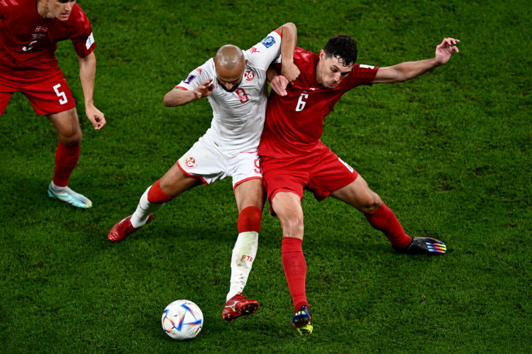 Tunisia's forward #09 Issam Jebali (L) fights for the ball with Denmark's defender #06 Andreas Christensen (R) during the Qatar 2022 World Cup Group D football match between Denmark and Tunisia at the Education City Stadium in Al-Rayyan, west of Doha on November 22, 2022.