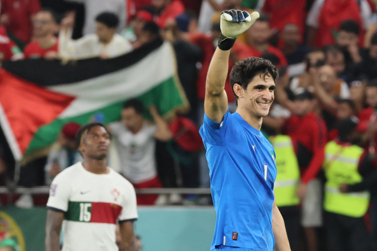 Morocco's goalkeeper #01 Yassine Bounou celebrates with supporters after his team won the Qatar 2022 World Cup quarter-final football match between Morocco and Portugal at the Al-Thumama Stadium in Doha on December 10, 2022. 