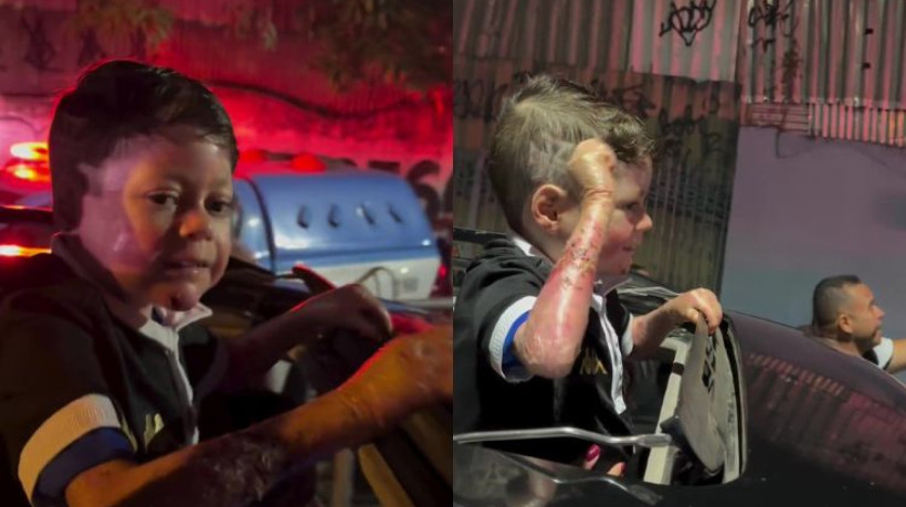 Menino Gui acena para torcedores do Vasco momentos antes da família ser assaltada. 