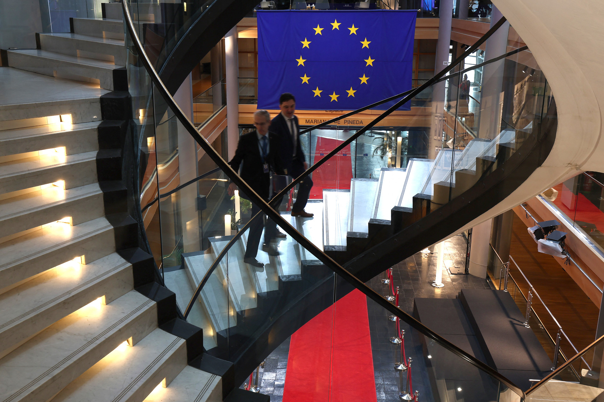Dois homens sobem as escadas durante uma sessão plenária no Parlamento Europeu em 17 de janeiro de 2024 em Estrasburgo, França (Foto: FREDERICO FLORIN/AFP)
