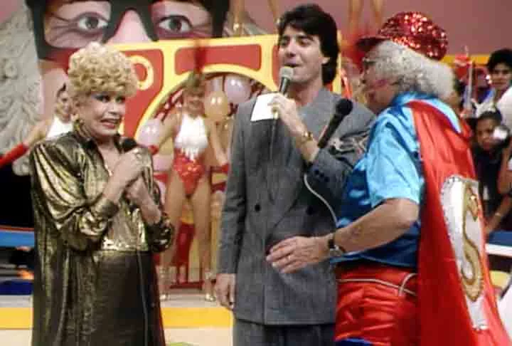 A atração de auditório foi ao ar entre 1982 e 1988, ano da morte do “Velho Guerreiro”. Nas últimas edições, chegou a ser apresentada por João Kleber (na foto com Chacrinha e Dercy Gonçalves).
