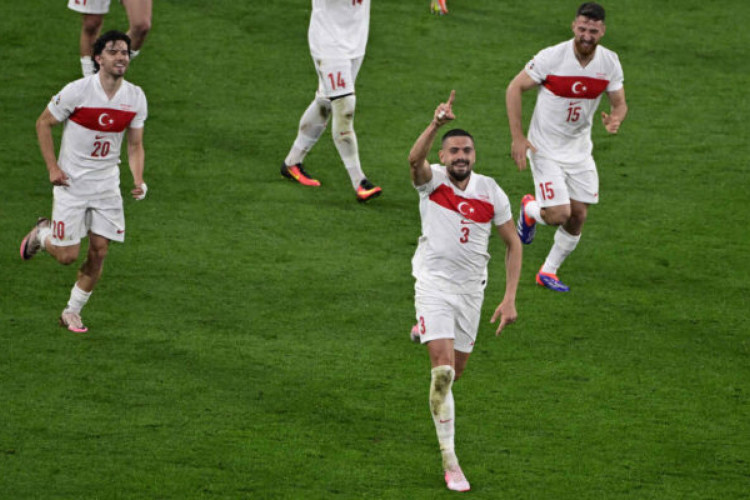 Turkey's defender #03 Merih Demiral celebrates with teammates after scoring his team's second goal during the UEFA Euro 2024 round of 16 football match between Austria and Turkey at the Leipzig Stadium in Leipzig on July 2, 2024. (Photo by JOHN MACDOUGALL / AFP)