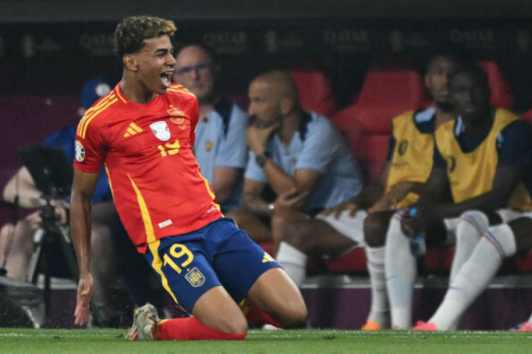 Spain's forward #19 Lamine Yamal celebrates scoring his team's first goal during the UEFA Euro 2024 semi-final football match between Spain and France at the Munich Football Arena in Munich on July 9, 2024. (Photo by MIGUEL MEDINA / AFP)