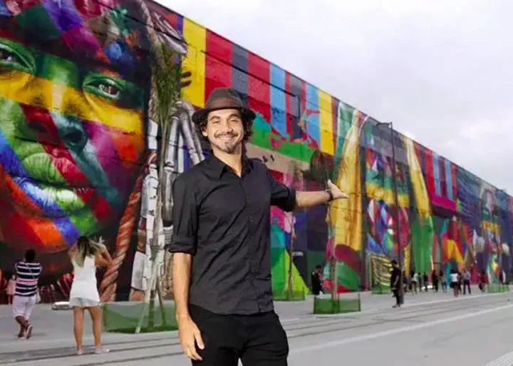 Eduardo Kobra - Nascido em 1º de janeiro de 1975, em São Paulo (SP), Kobra começou sua carreira no grafite nos anos 1980, durante a adolescência, e rapidamente se destacou por seu estilo único e habilidade técnica.