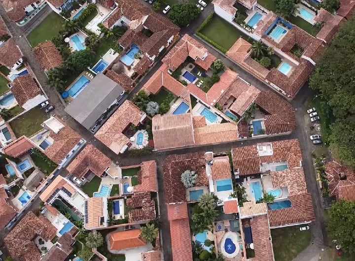 Com mais de 190 residências e alguns hotéis, o lugar é conhecido por sua arquitetura com casas, varandas e portas coloridas.