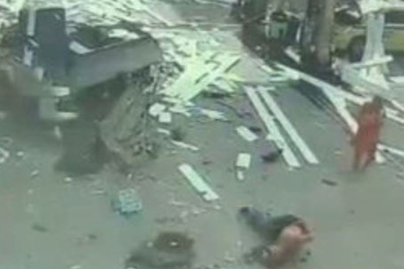 O homem foi arremessado a alguns metros e ficou no chão, ferido.  Veja que ele está sem camisa. Parte da roupa foi arrancada pela força da explosão. 