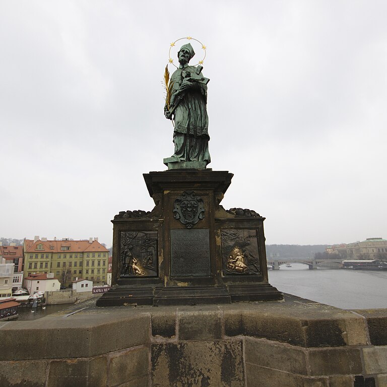 Segundo a lenda, ele foi jogado do alto da ponte por ordem do rei Venceslau IV por se recusar a revelar o segredo de confissão da rainha. Hoje, acredita-se que tocar na base da estátua com a mão esquerda e fazer um pedido garante a realização de um desejo.
