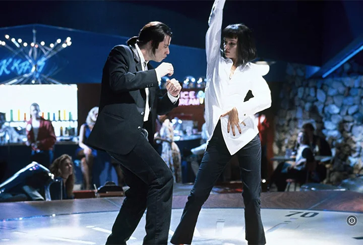 Já na obra de Tarantino, ele vive Vincent Vega, um assassino profissional. Em uma das cenas, curiosamente, ele dança. E muito bem, claro. 