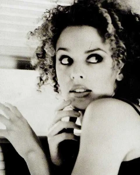 A artista australiana começou a ganhar holofotes como atriz, na novela local Neighbours, nos anos 1980. Na trama, ela fez o papel da personagem Charlene Robinson. 
