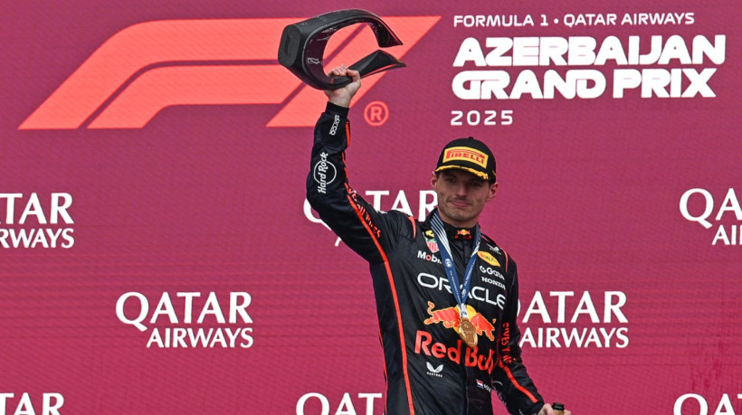 Red Bull Racing's Dutch driver Max Verstappen celebrates with his trophy on the podium after the Formula One Azerbaijan Grand Prix at the Baku City Circuit in Baku on September 21, 2025.