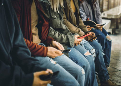 Millenial people watching smart mobile phones outside - Teens using modern technology - Young people addicted to cellphones 
