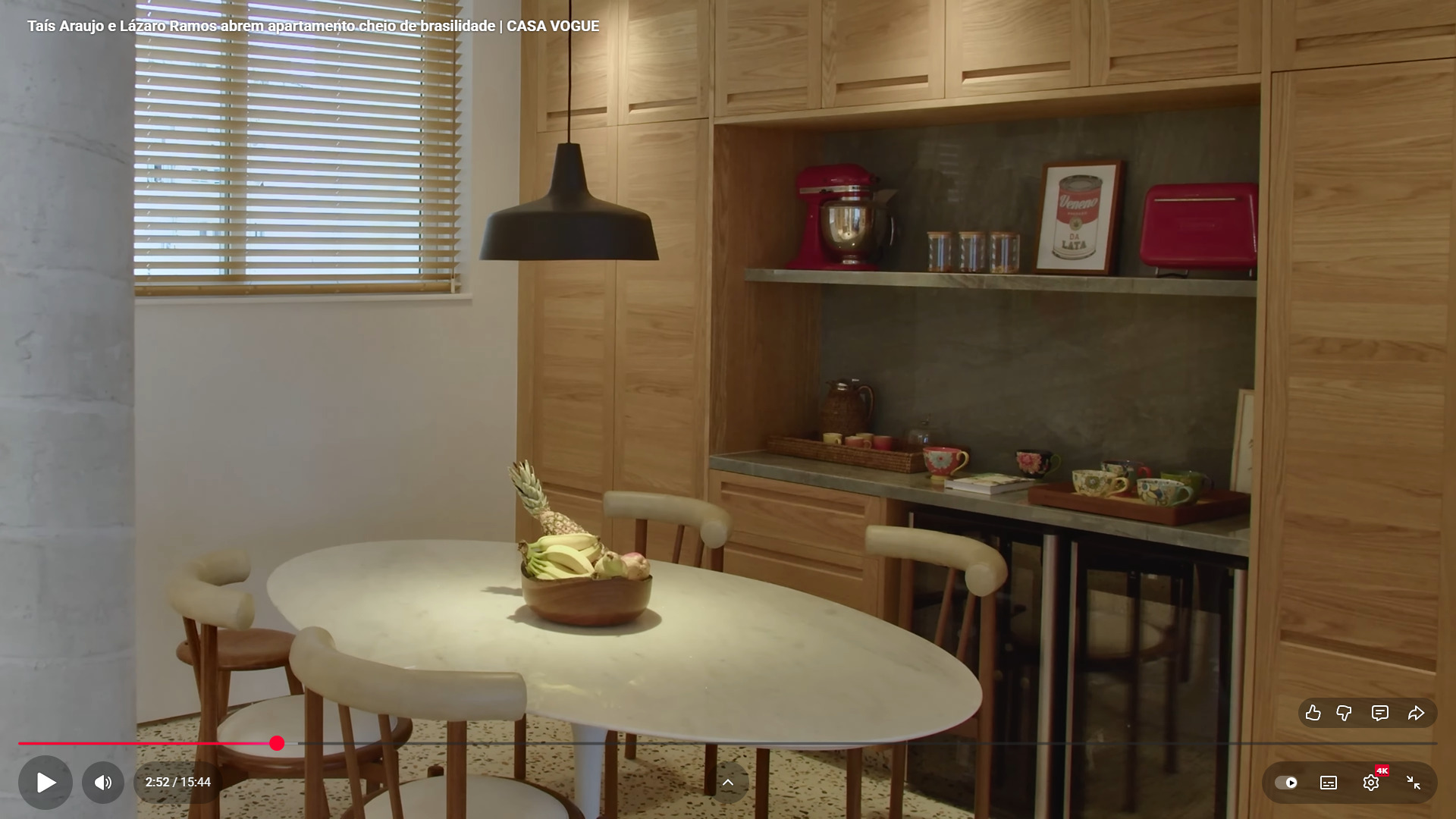 A paleta de cores mistura tons terrosos, rosados e verdes, reforçando o clima acolhedor.
