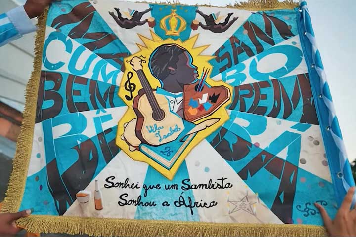 Segundo a escola, a proposta é oferecer um desfile “com as tintas do pertencimento”, exaltando a ancestralidade e a força criativa negra que moldaram o samba carioca.
