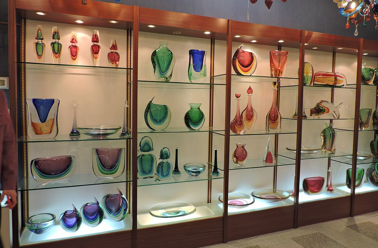 As peças de Murano combinam elegância clássica com ousadia cromática. Vasos, lustres e esculturas exibem formas fluidas e cores vibrantes em uma estética que reflete tanto a herança veneziana quanto a busca por inovação. O vidro, assim, tornou-se expressão artística e objeto de desejo internacional.