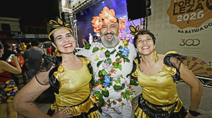 Alana Freire (esq.) e Aline Mendes (dir.), com amigo vestido de flor, no centro