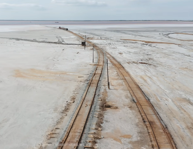 Mas o mais impressionante vem agora. Com o intuito de extrair os minerais, foi instalada uma estrutura no leito do lago, composta por trilhos que permitem a passagem de um trem.